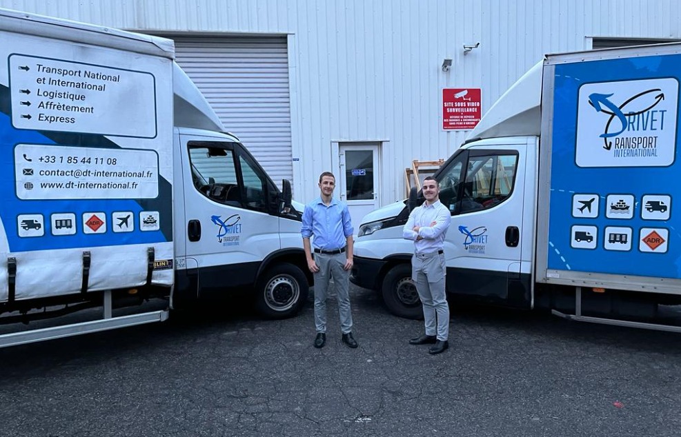 Equipo de Drivet Transport International delante de sus vehículos