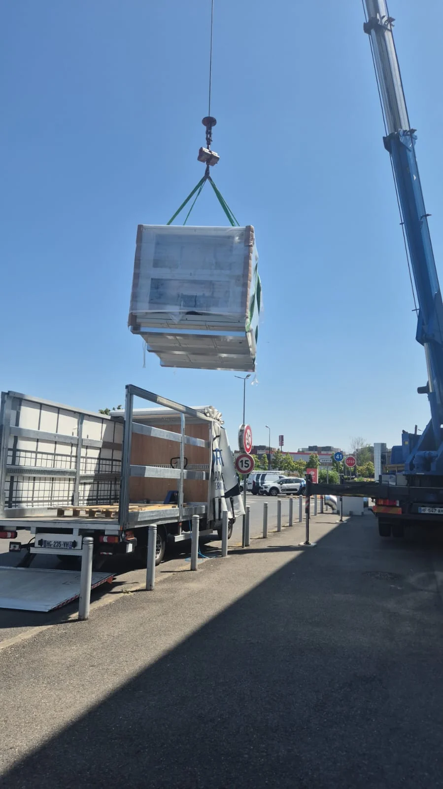 Chargement vertical par grue dans un véhicule léger bâché